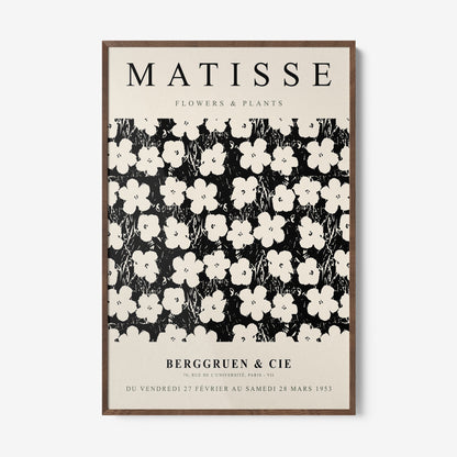 framed wall art featuring floral design in black and white with dark wood frame and light background