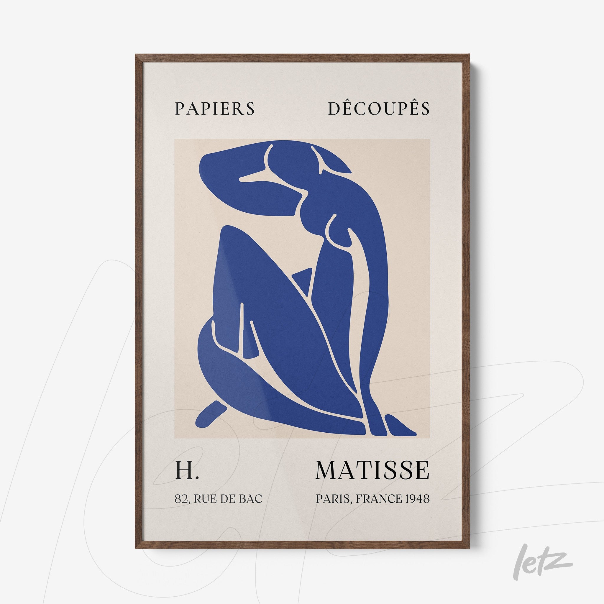 framed abstract art of a seated female figure in blue with dark wooden frame and light background