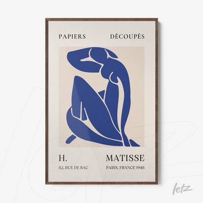framed abstract art of a seated female figure in blue with dark wooden frame and light background