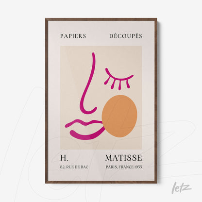 framed modern art featuring abstract shapes in pink and orange on a cream background with dark wood frame