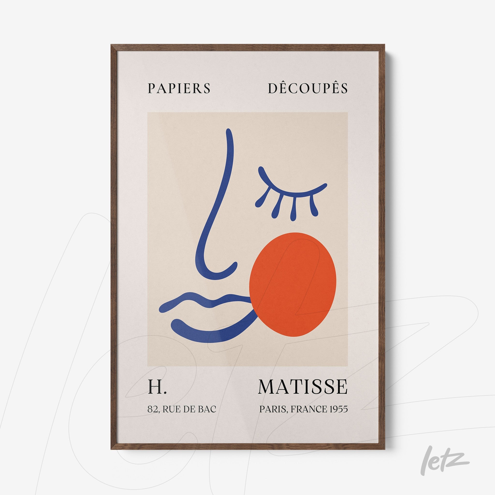 framed artwork featuring a stylized abstract face in dark wood frame with neutral background