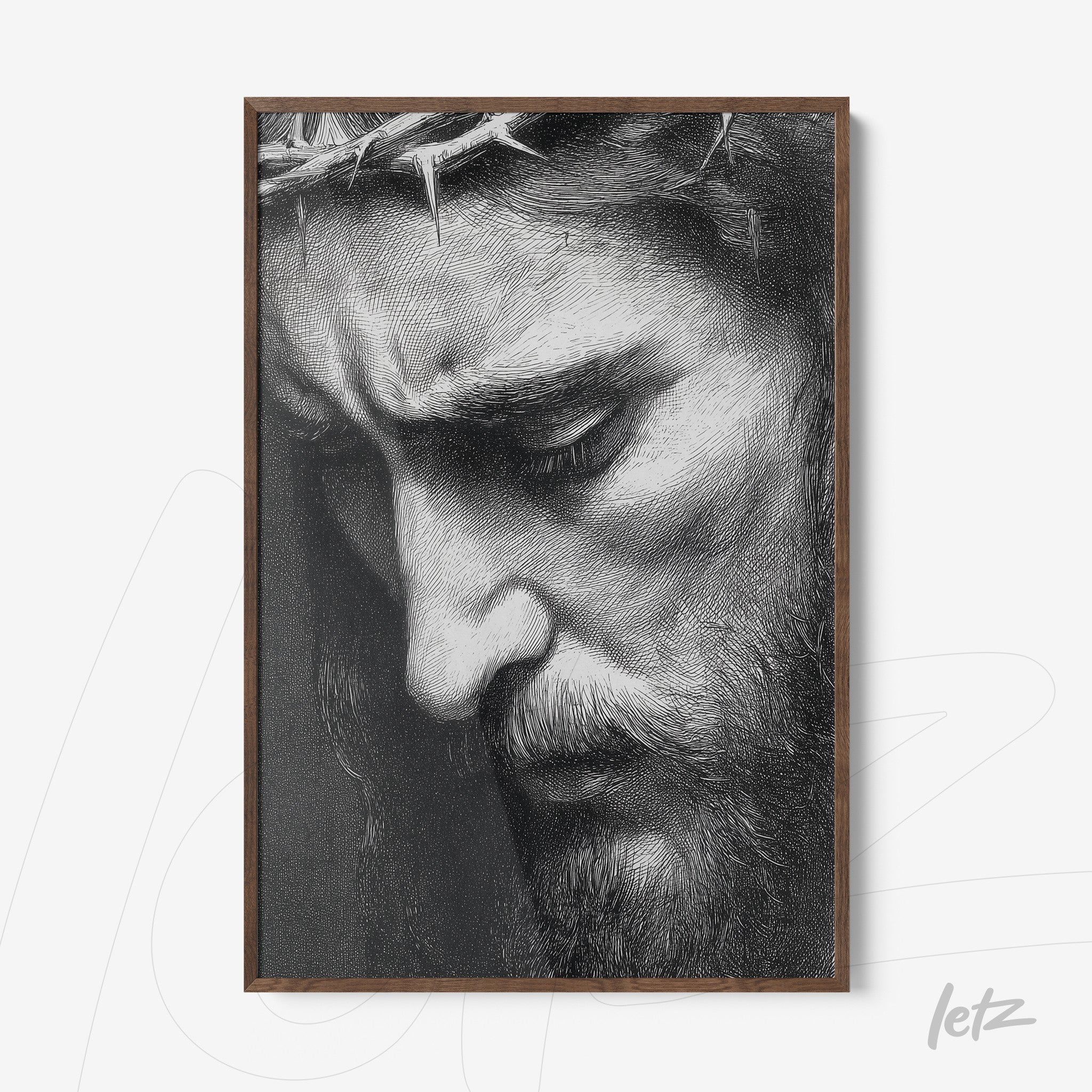 framed black and white portrait of a man with a serene expression and crown of thorns in dark wood frame