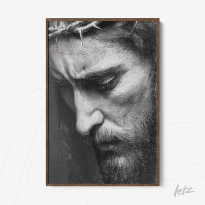 framed black and white portrait of a man with a serene expression and crown of thorns in dark wood frame