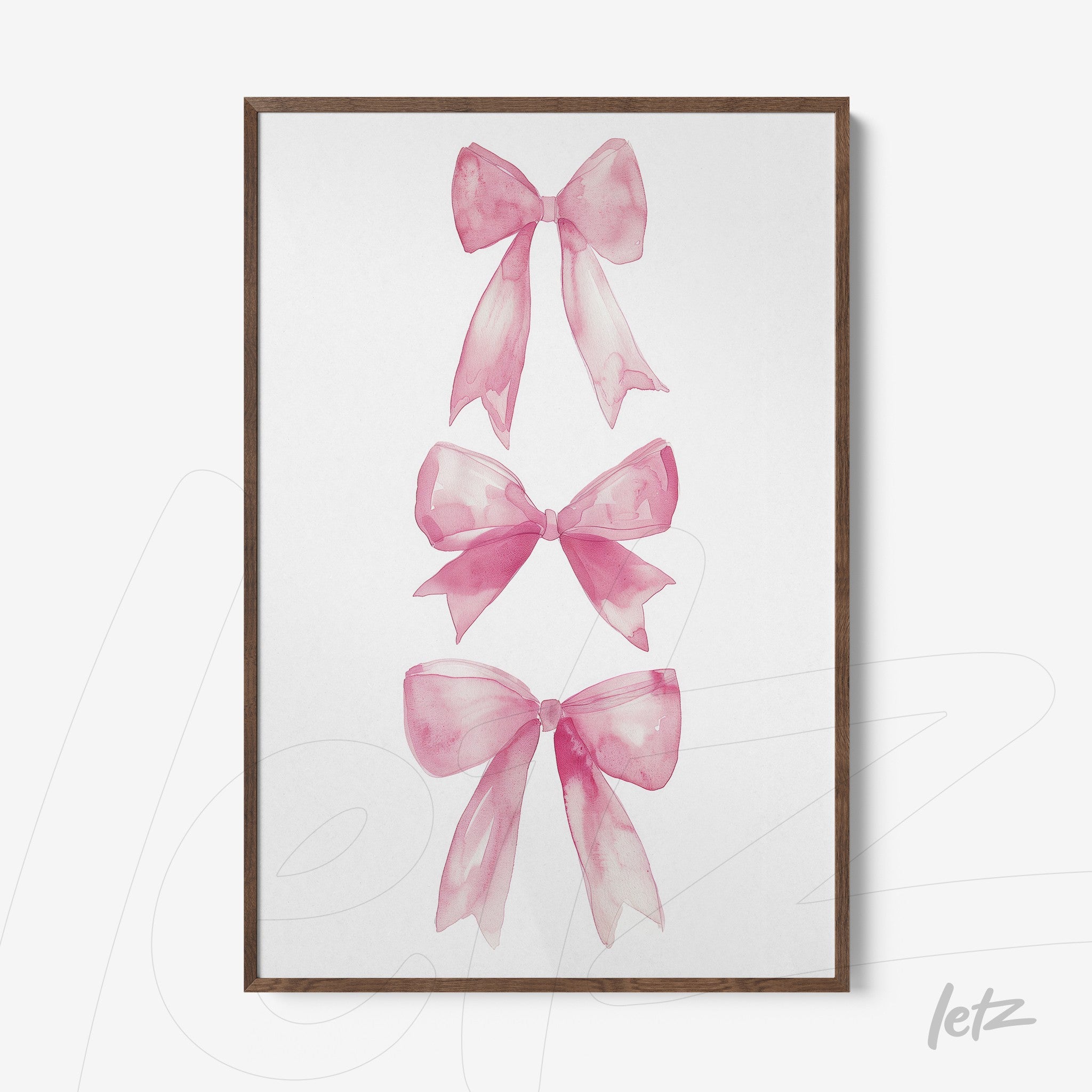 framed artwork of pink watercolor bows in light wood frame