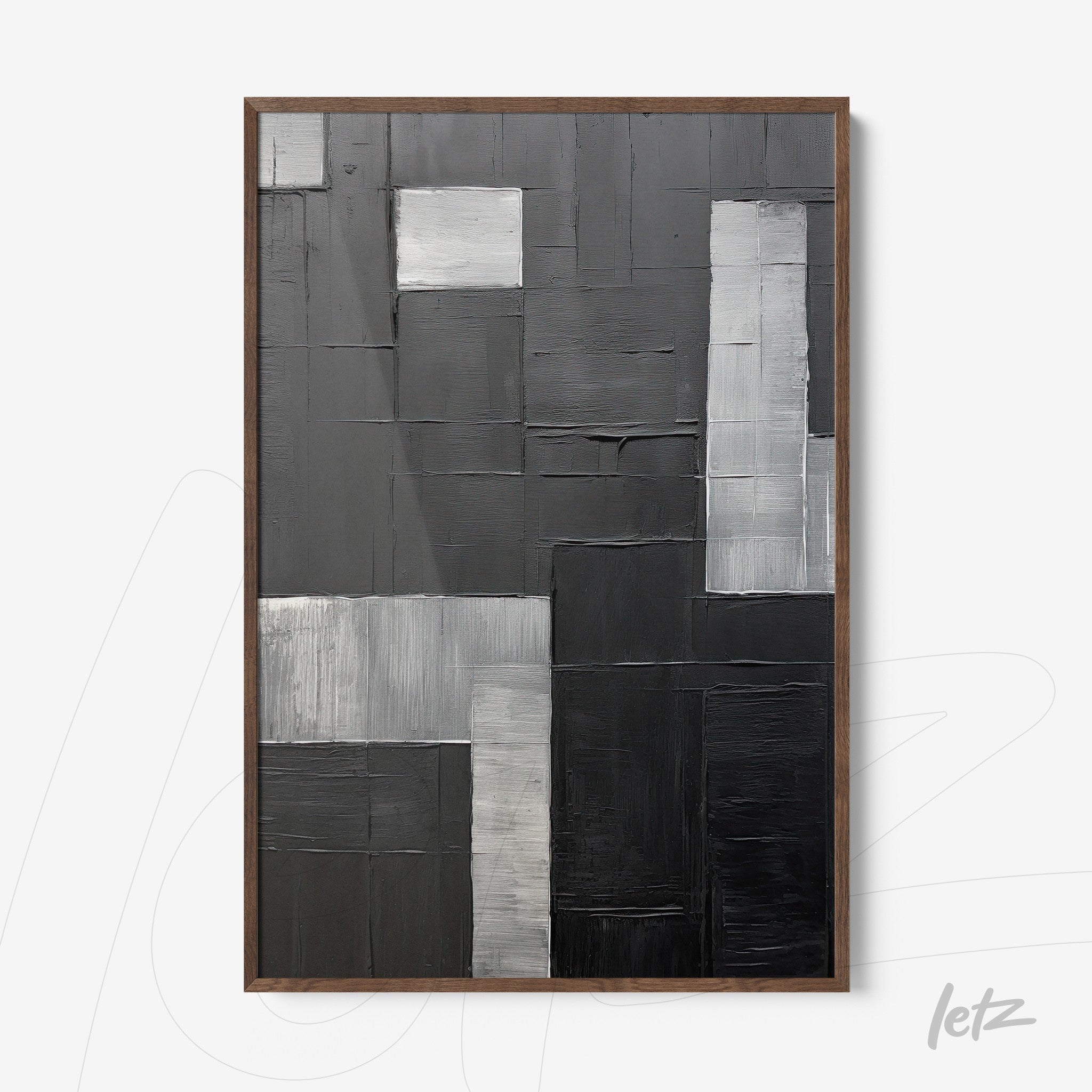 abstract wall art in shades of black and gray featuring textured surface and dark wood frame