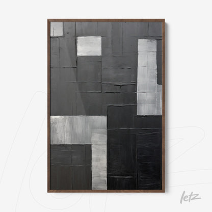 abstract wall art in shades of black and gray featuring textured surface and dark wood frame