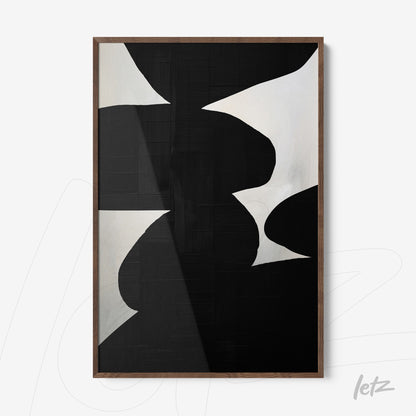 framed abstract art in black and white with dark wood frame and textured background
