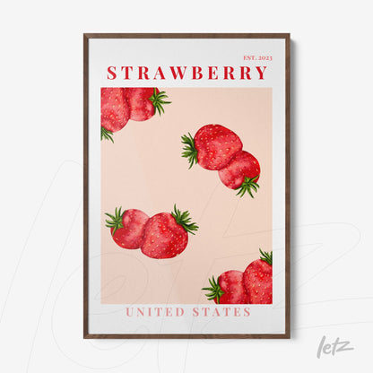 framed wall art featuring strawberries on a pink background with dark wood frame