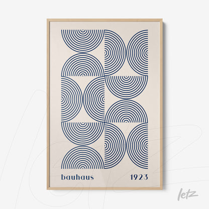 canvas print featuring bauhaus geometric art with concentric blue circles on a light background and a light wood frame