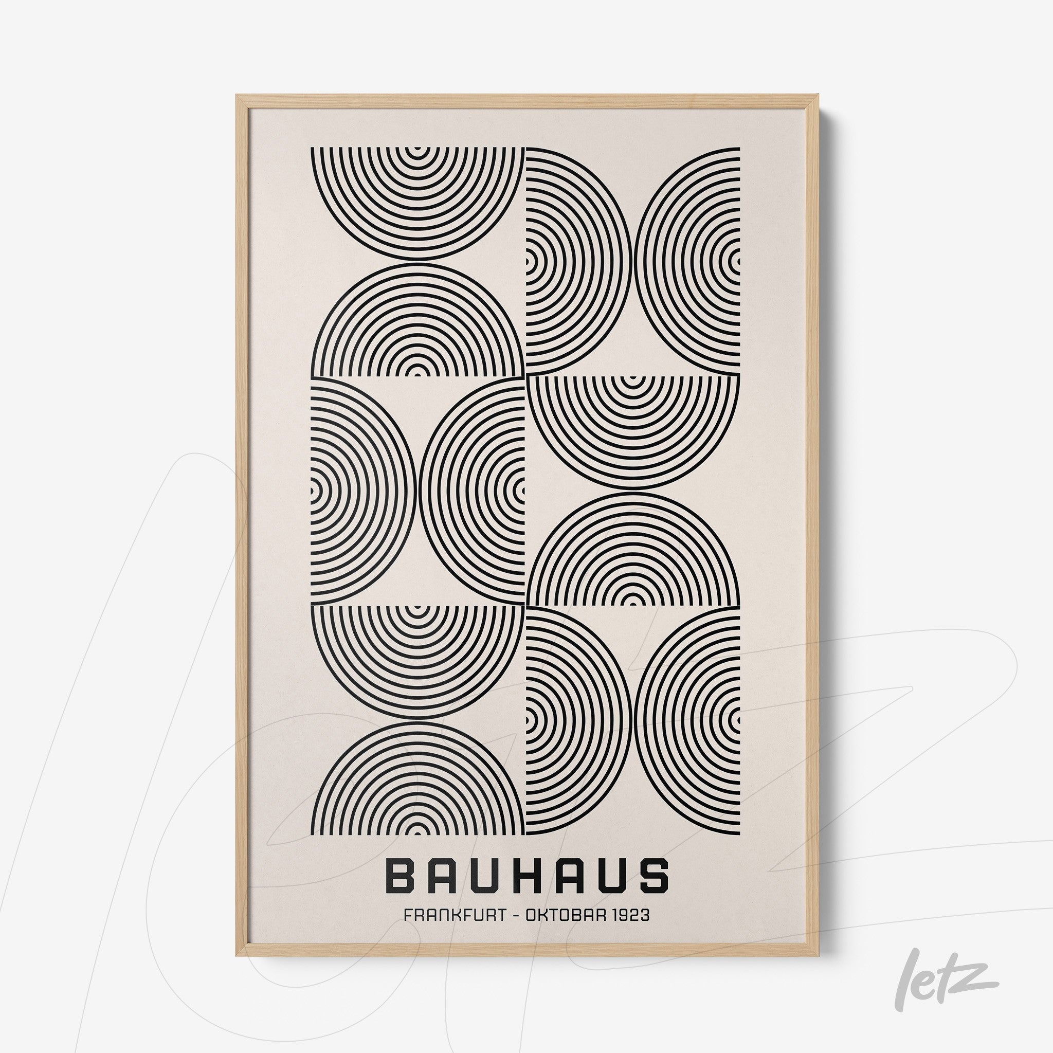 poster with geometric black and white bauhaus style art, framed with light wood