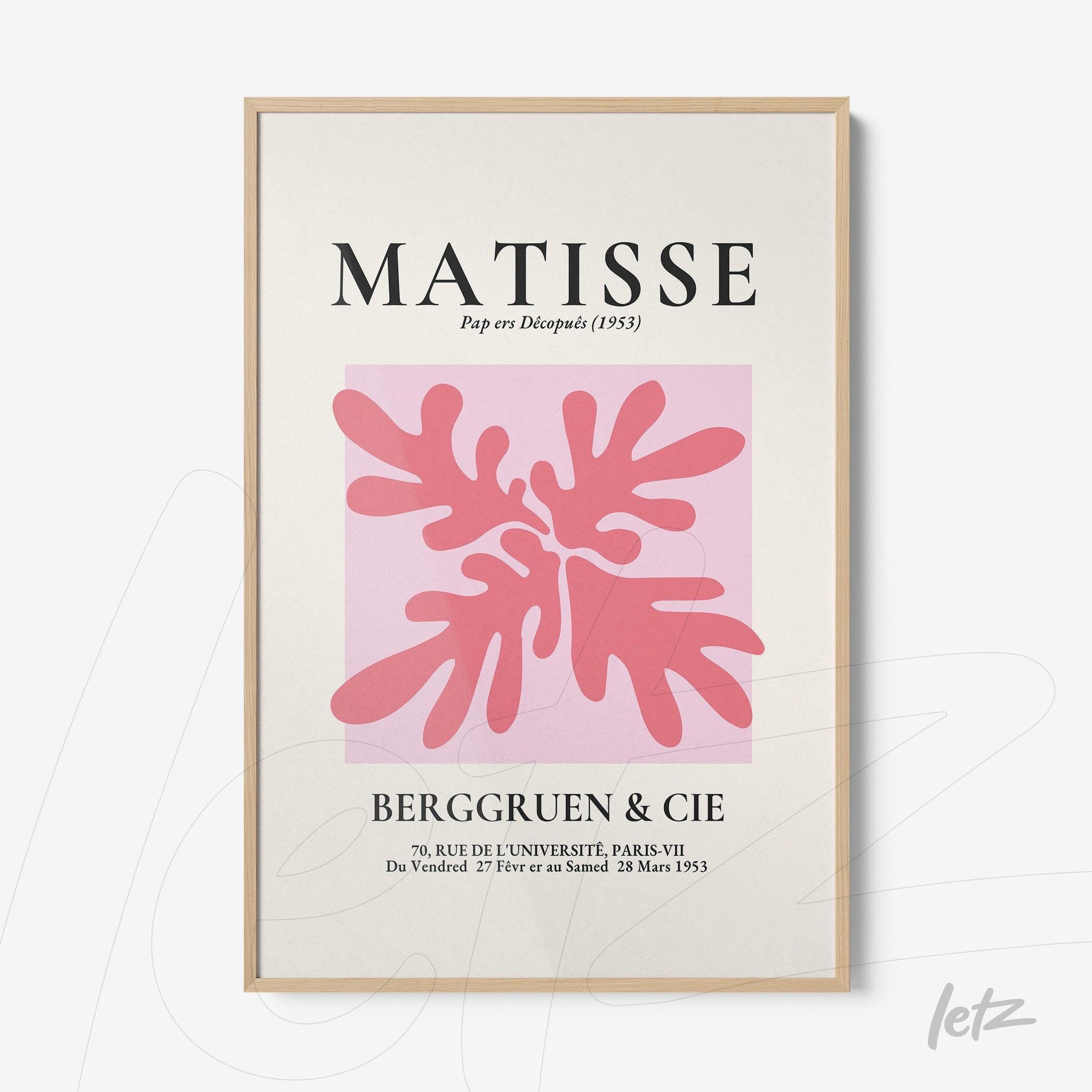 framed modern art print featuring pink leaves on a light background with a light wood frame