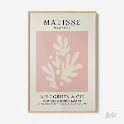 framed modern art print on pink background featuring abstract white shapes with light wood frame