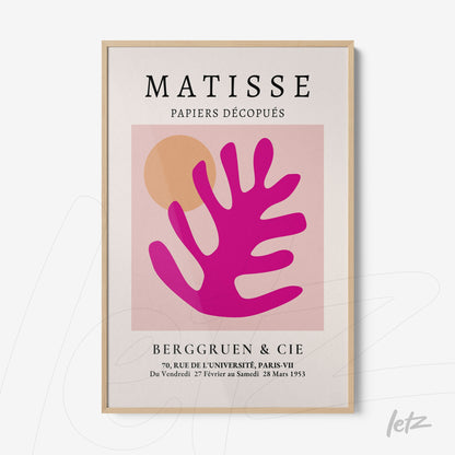 framed wall art featuring abstract design in shades of pink and orange, light wood frame, beige background