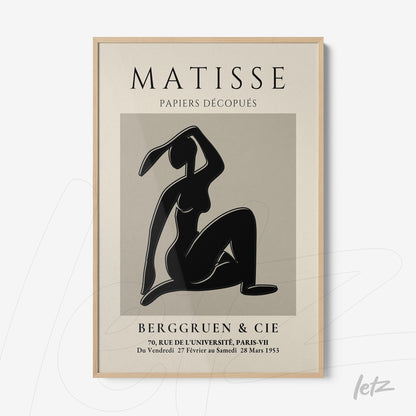 framed artwork of cut-outs by Matisse in light wood frame