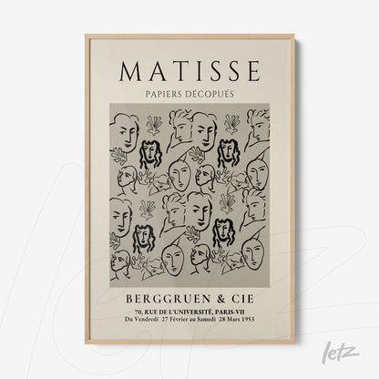 framed wall art featuring abstract design with stylized faces in black lines against gray background, light wood frame