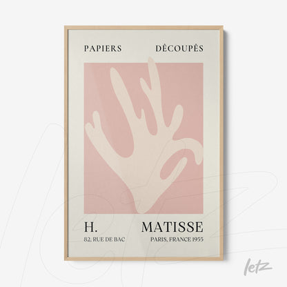framed art inspired by henri matisse featuring an abstract silhouette in pink tones on cream background with light wood frame