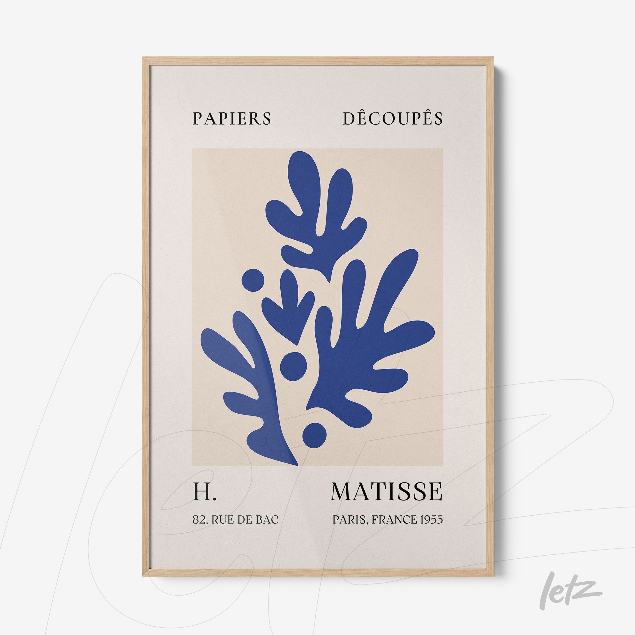 framed modern art print featuring blue organic shapes on beige background inspired by matisse with light wood frame