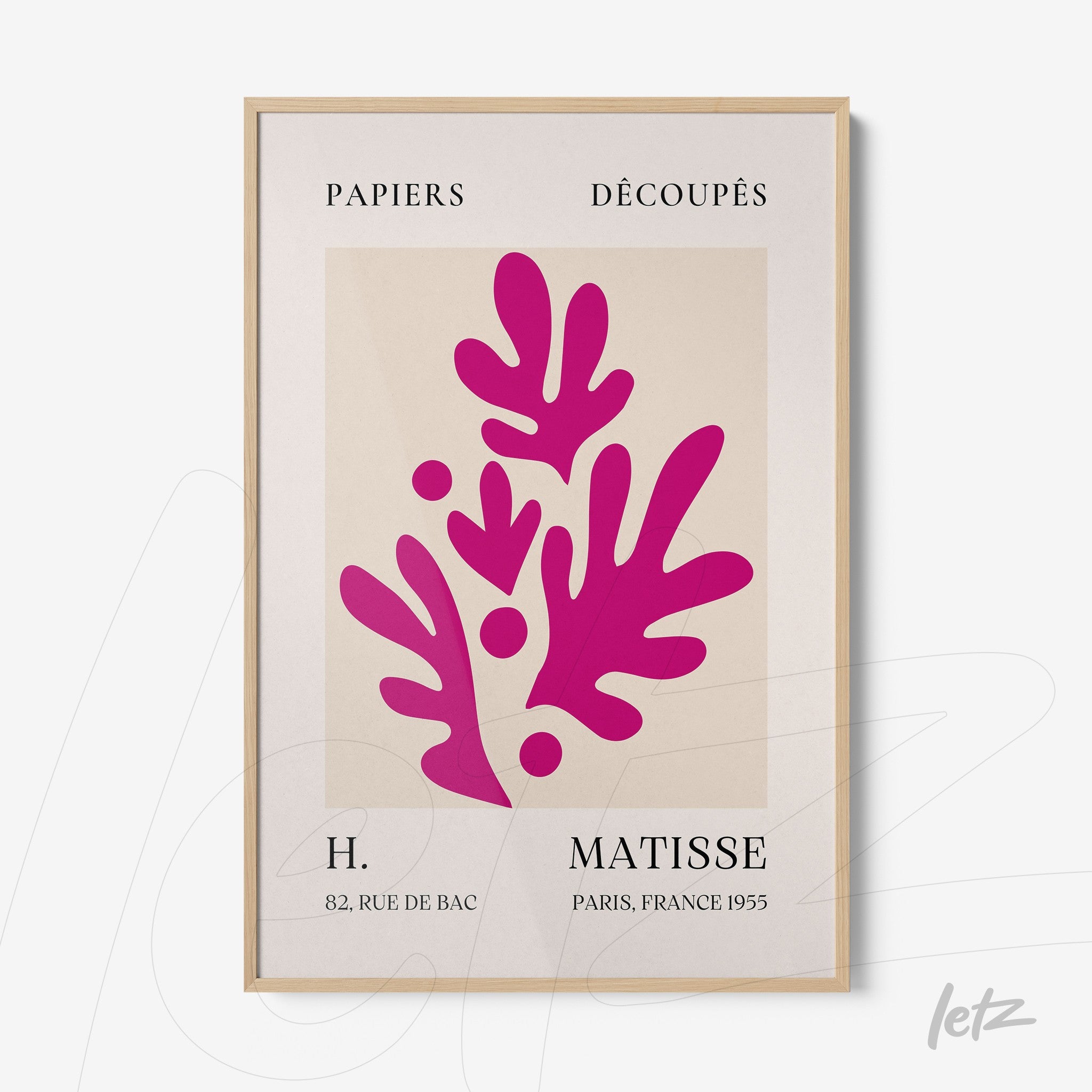 framed modern art piece featuring pink botanical shapes on a light background with natural wood frame