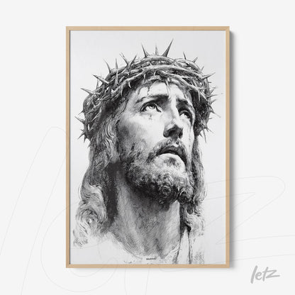 framed black and white artwork depicting the face of Jesus with a crown of thorns in a light wood frame