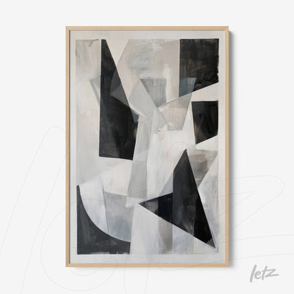 abstract wall art in shades of black, white, and gray with a light wooden frame