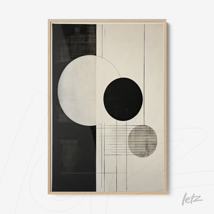 framed wall art featuring an abstract composition in black and white with textured circles and light wood frame