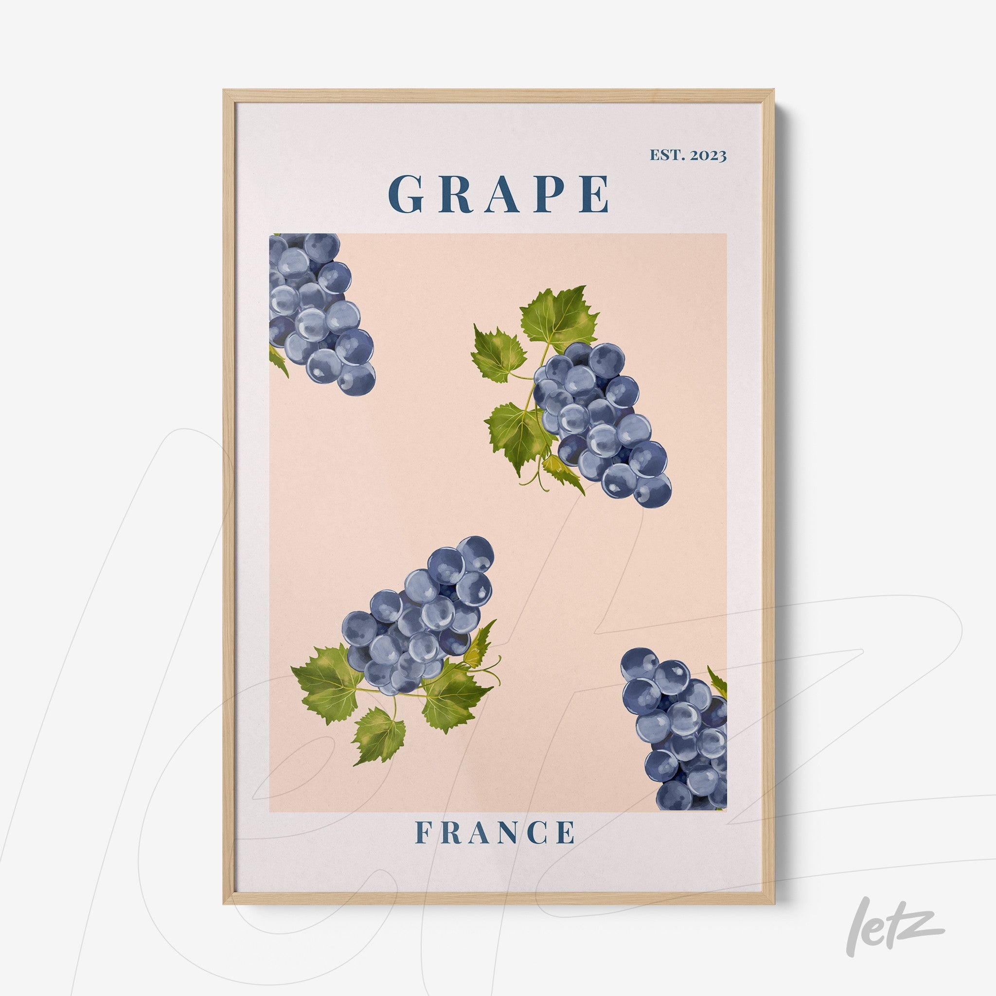 framed artwork featuring grapes on a pink background with light wood frame