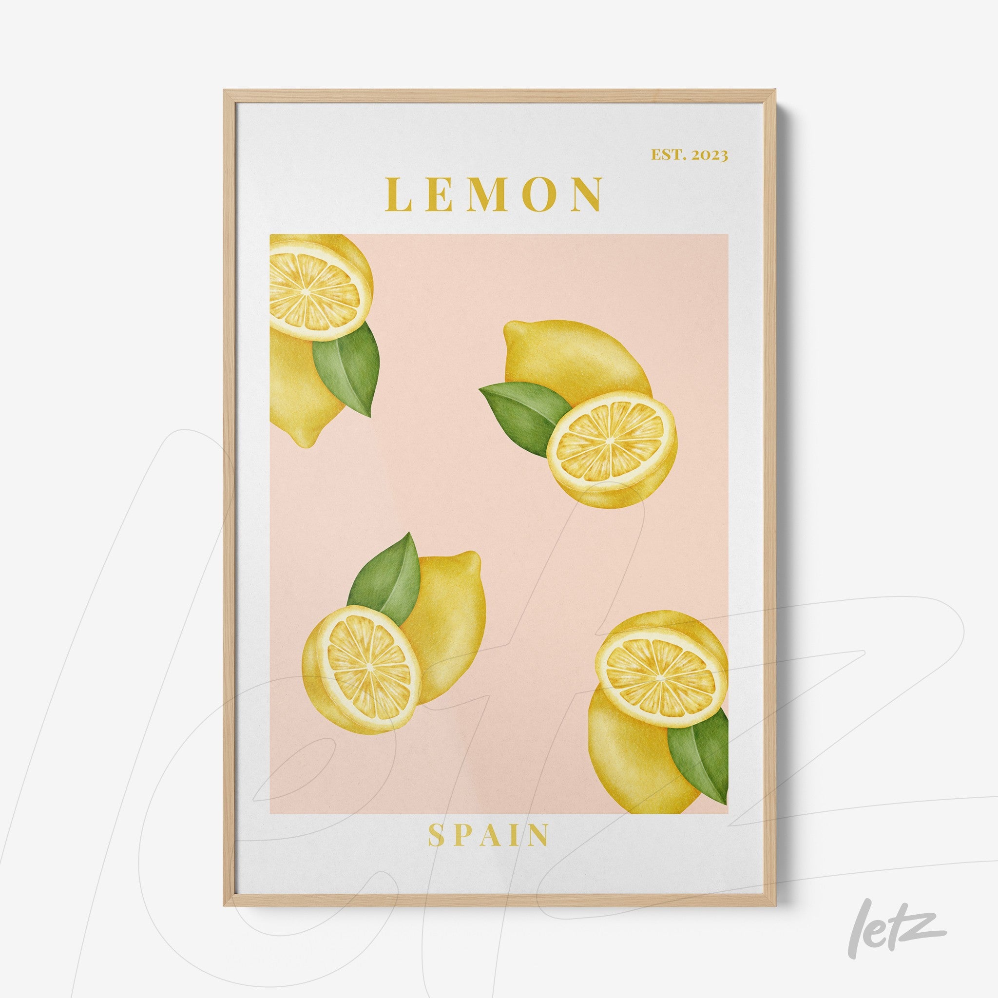 framed art featuring lemons on a light pink background with a light wood frame and yellow accents