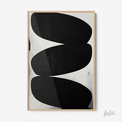 framed artwork featuring abstract black and white shapes against a textured background