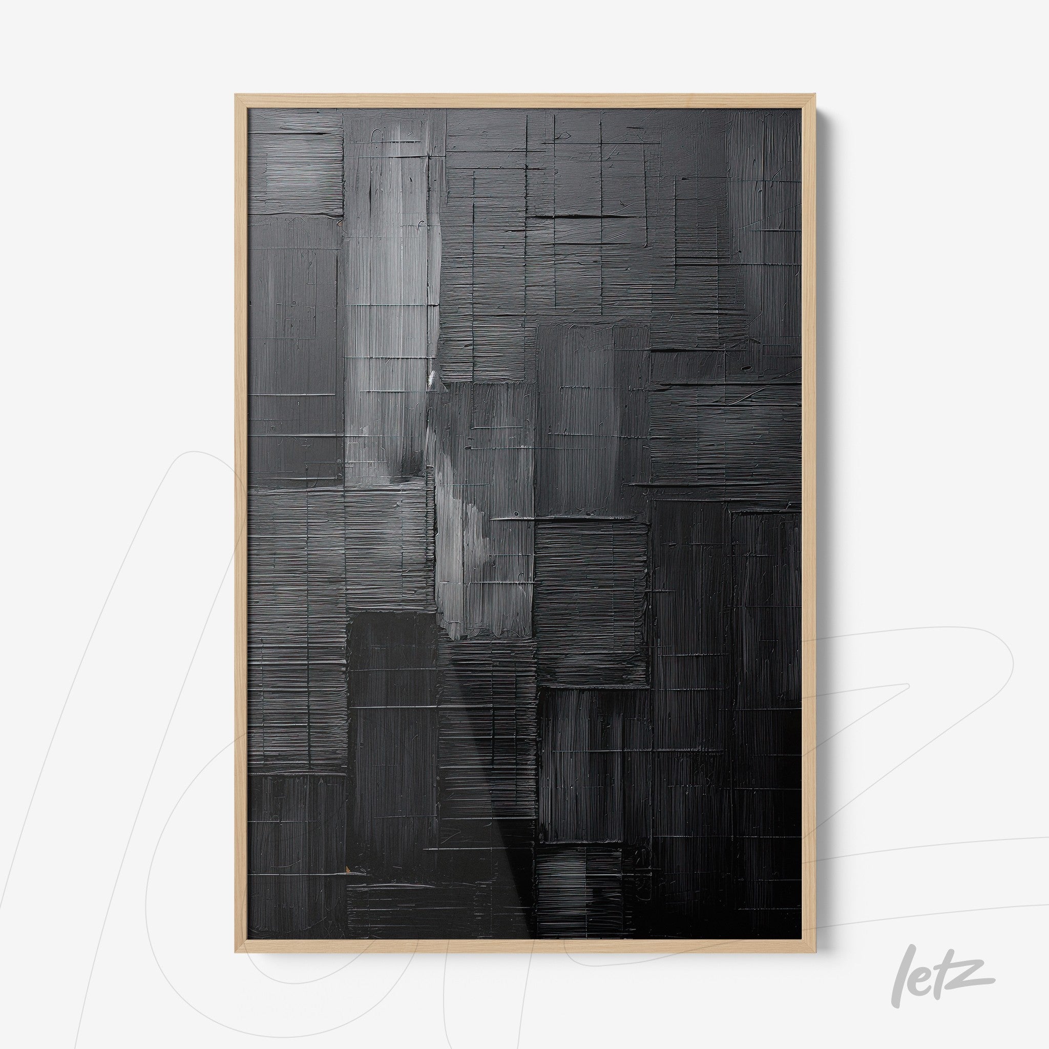 framed abstract wall art in shades of black and gray with light frame