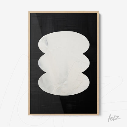 framed abstract wall art featuring white oval shapes on a black background with light wood frame