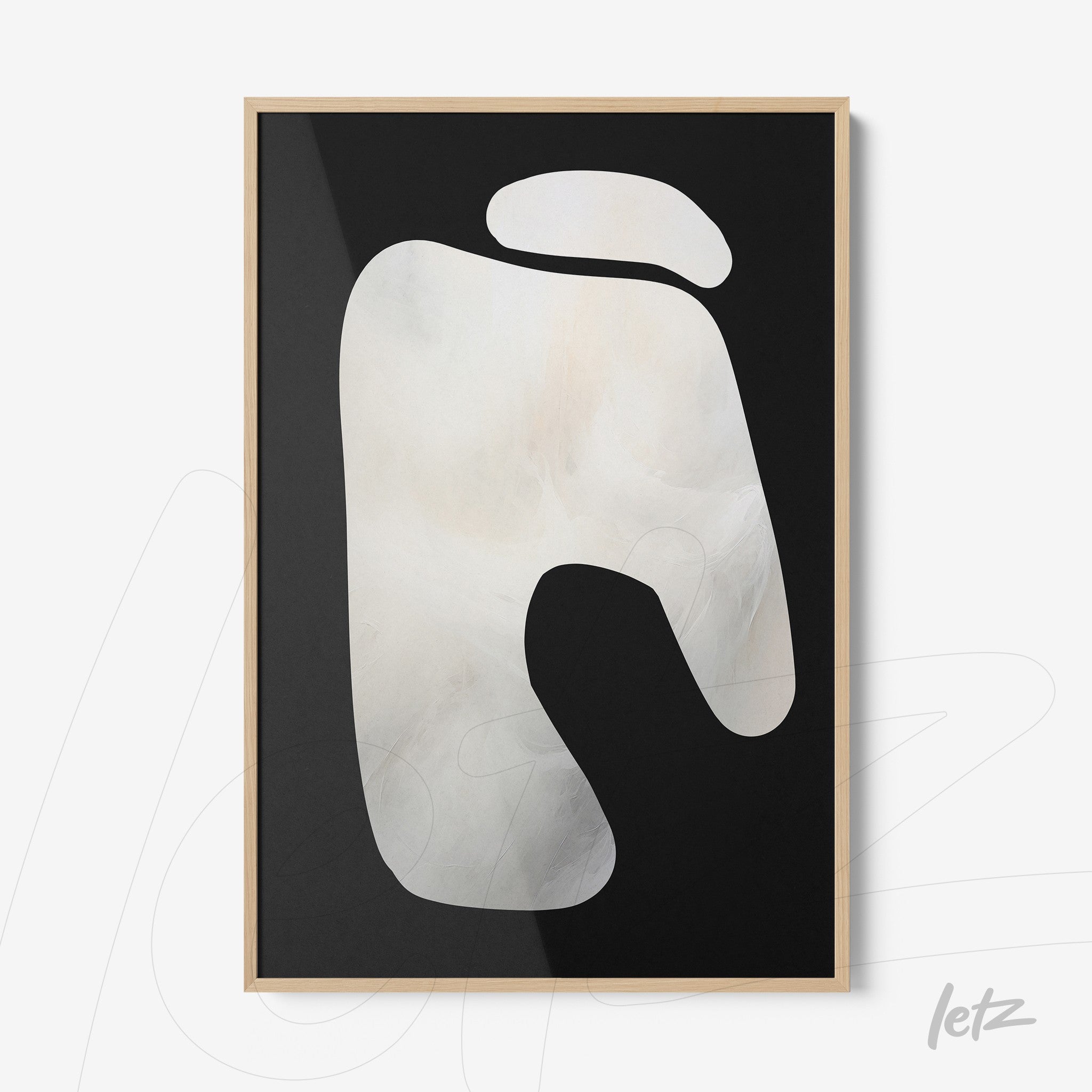 abstract wall art in black and white featuring organic shapes framed in light wood