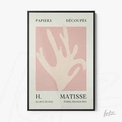 framed wall art featuring an abstract hand design on a light pink background