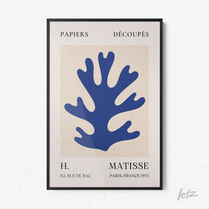 framed modern art featuring blue cut-out shapes resembling leaves with black frame