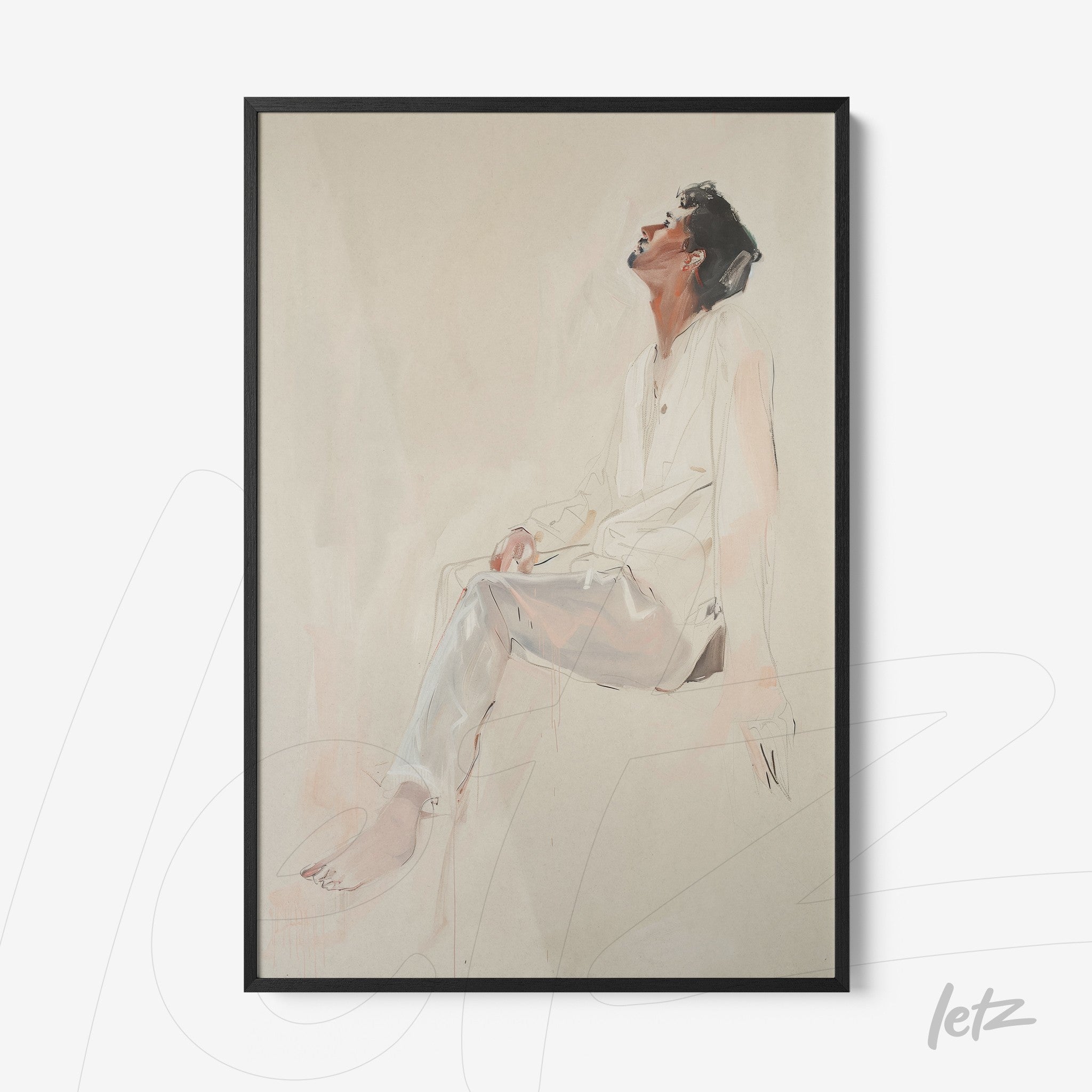 artistic wall art of a man sitting in a contemplative pose on a soft background with a black frame