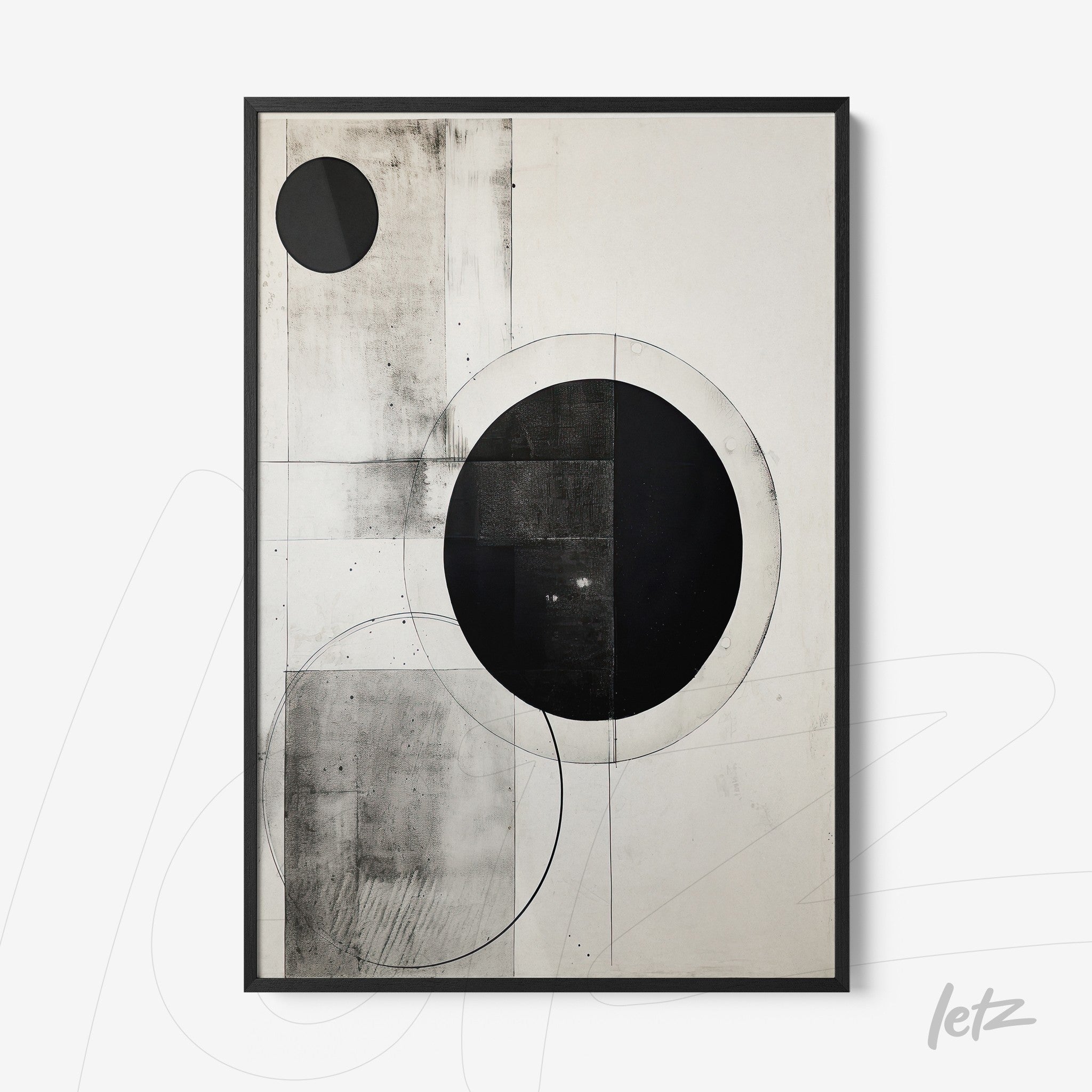 framed abstract art in black and white featuring circular geometric shapes in a minimalist composition with black frame