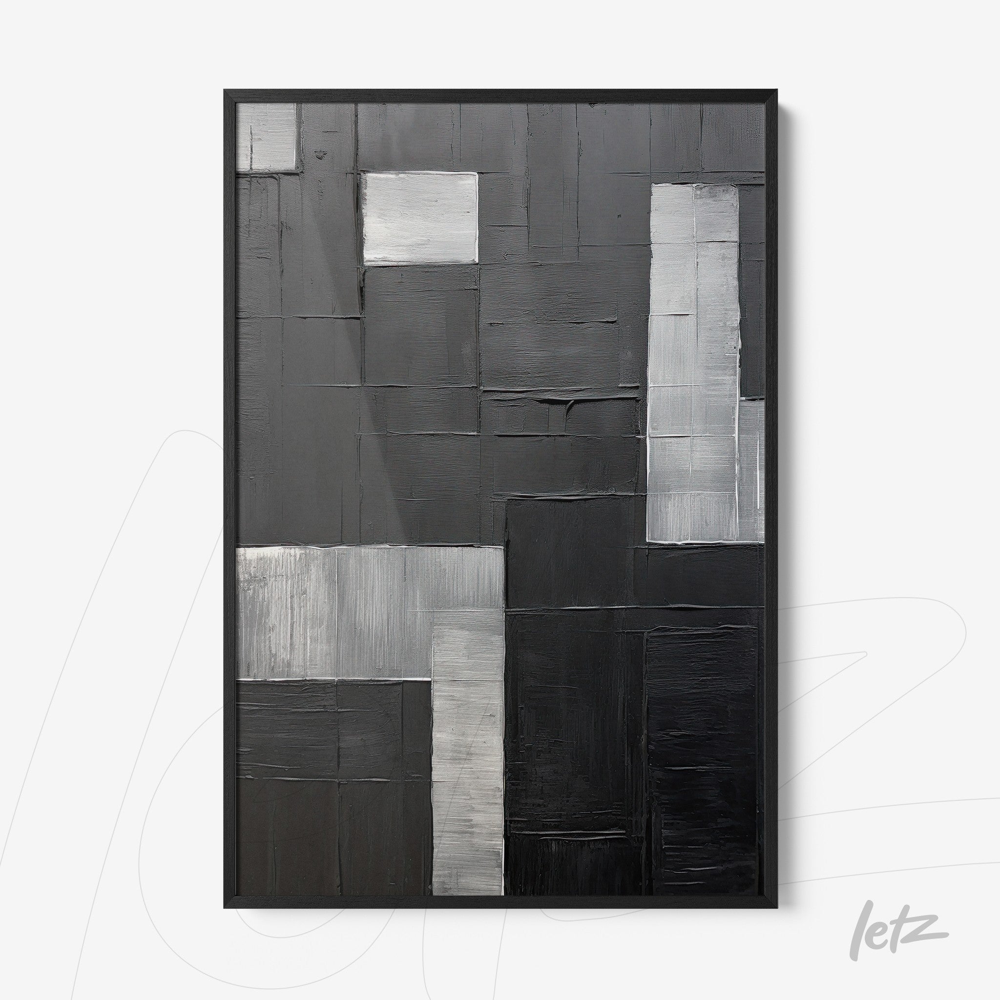 abstract wall art in shades of black and gray with black frame