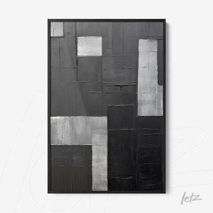 abstract wall art in shades of black and gray with black frame