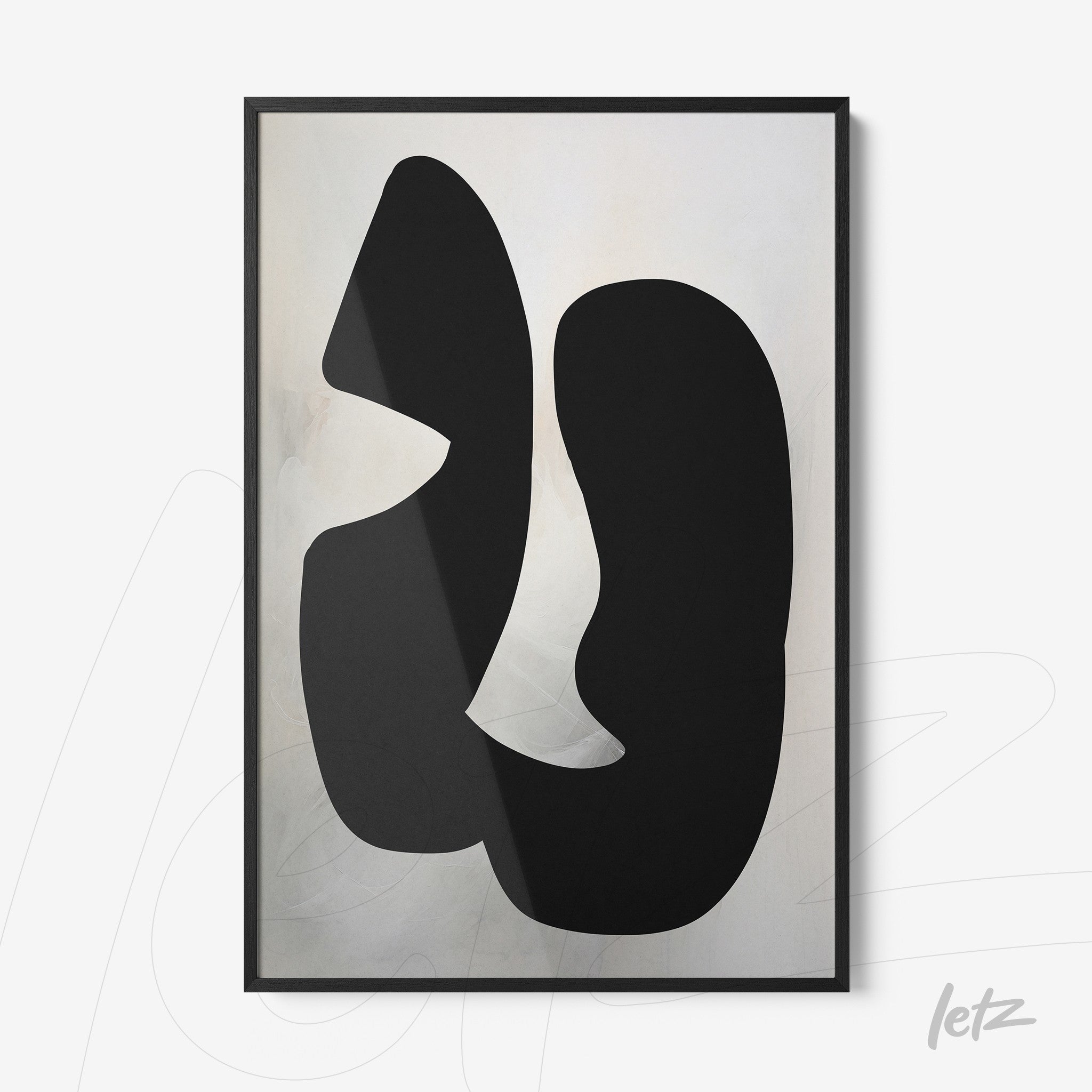 framed abstract art featuring black shapes on a light background