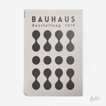 rectangular poster print with stylized circles illustration on beige background and text 'Bauhaus Ausstellung 1919'