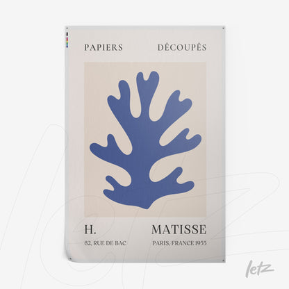 framed wall art featuring a stylized blue sea plant on a light background with decorative text at the bottom